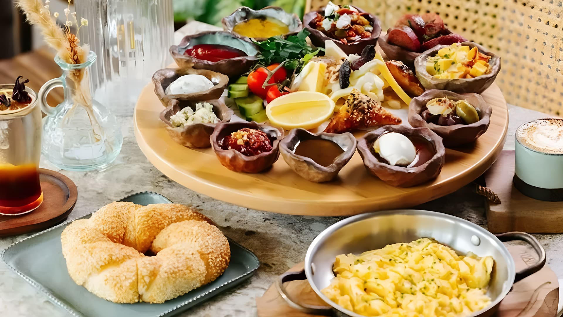 Traditional Turkish breakfast spread in Dubai with cheeses, olives, fresh bread, eggs, and coffee served at BohoX.