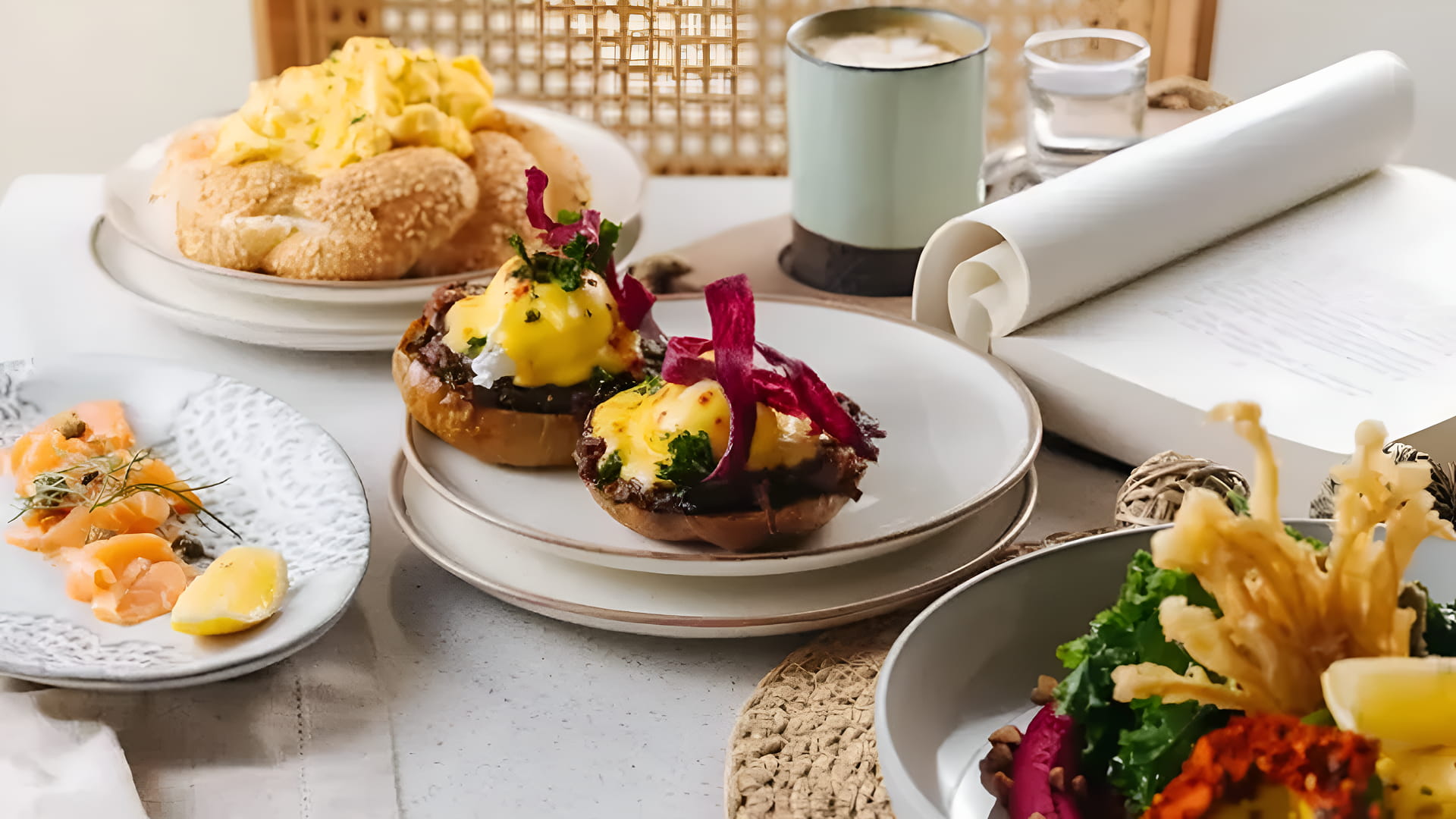 All-day breakfast in Dubai featuring eggs benedict, smoked salmon, fresh bread, and coffee served at BohoX.