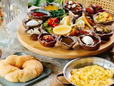 Traditional Turkish breakfast spread in Dubai with cheeses, olives, fresh bread, eggs, and coffee served at BohoX.