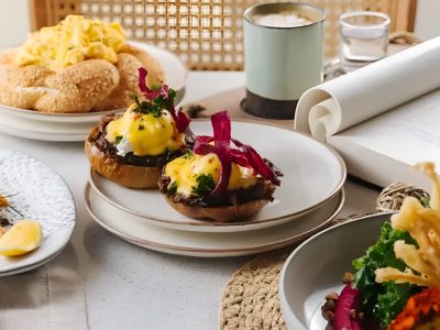 All-day breakfast in Dubai featuring eggs benedict, smoked salmon, fresh bread, and coffee served at BohoX.